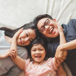 laughing family of three