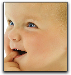 A small boy putting his finger in mouth