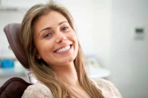 Girl smiling sitting at the dentist clinic